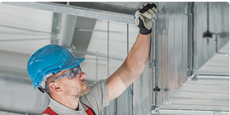 Worker checking an HVAC system